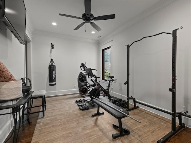 exercise room featuring recessed lighting, baseboards, wood finished floors, and crown molding