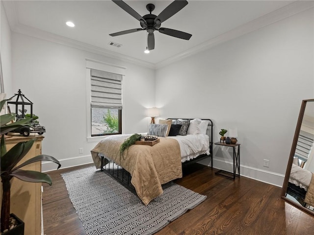 bedroom featuring ornamental molding, baseboards, and wood finished floors