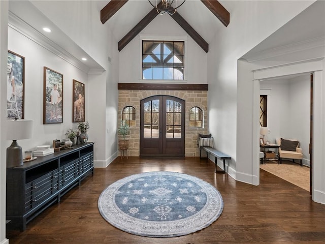 entrance foyer featuring french doors, beam ceiling, high vaulted ceiling, and wood finished floors