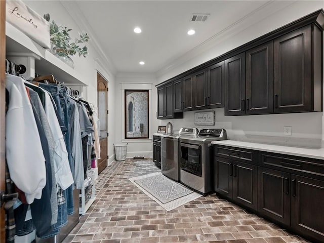 laundry area featuring visible vents, recessed lighting, cabinet space, crown molding, and washer and clothes dryer