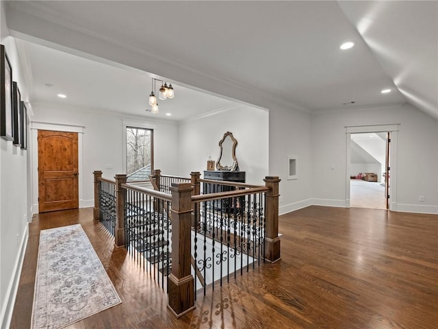 interior space featuring wood finished floors, recessed lighting, an upstairs landing, and baseboards