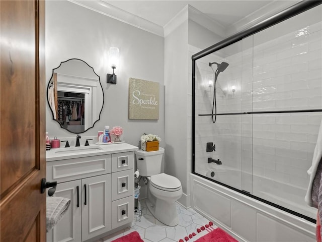 full bath featuring tile patterned floors, crown molding, toilet, enclosed tub / shower combo, and vanity