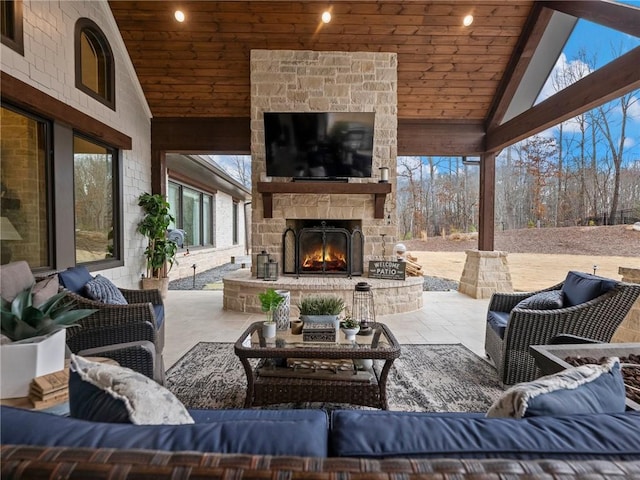 view of patio with an outdoor living space with a fireplace