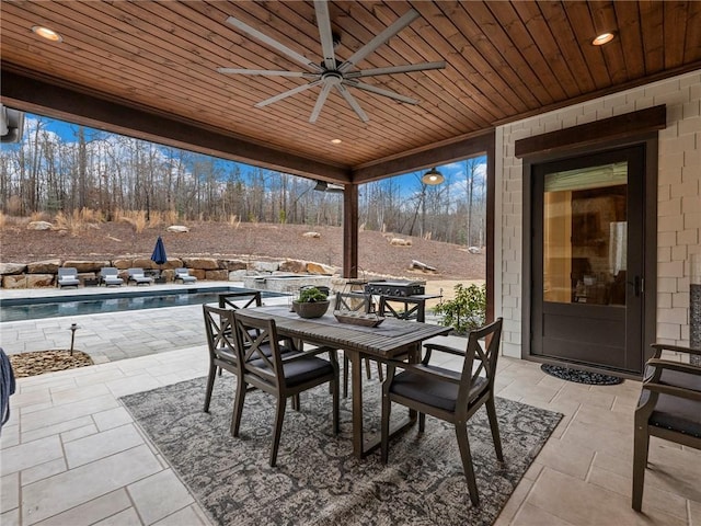 view of patio / terrace featuring an outdoor pool, outdoor dining area, and a ceiling fan