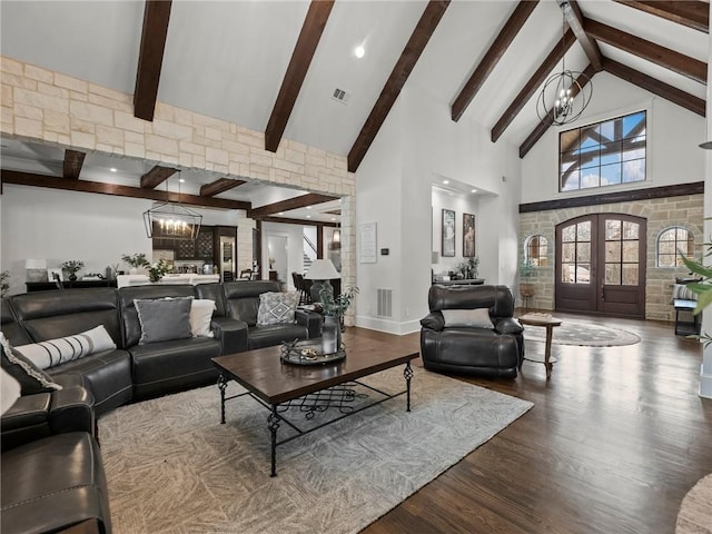 living room featuring dark wood-style floors, visible vents, high vaulted ceiling, an inviting chandelier, and french doors