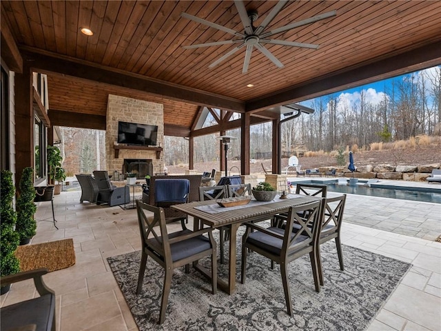 view of patio / terrace featuring an outdoor living space with a fireplace, an outdoor pool, outdoor dining area, and a ceiling fan