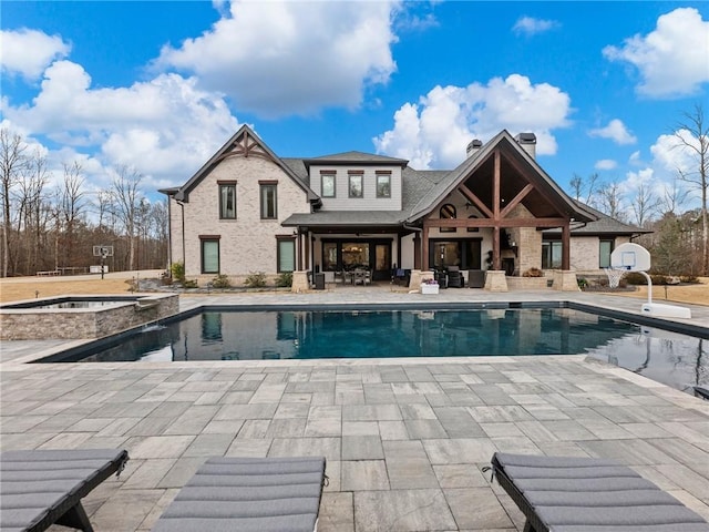 view of swimming pool featuring a patio area and a pool with connected hot tub