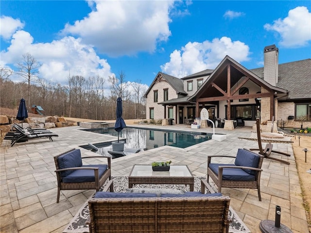 outdoor pool featuring an outdoor hangout area and a patio area