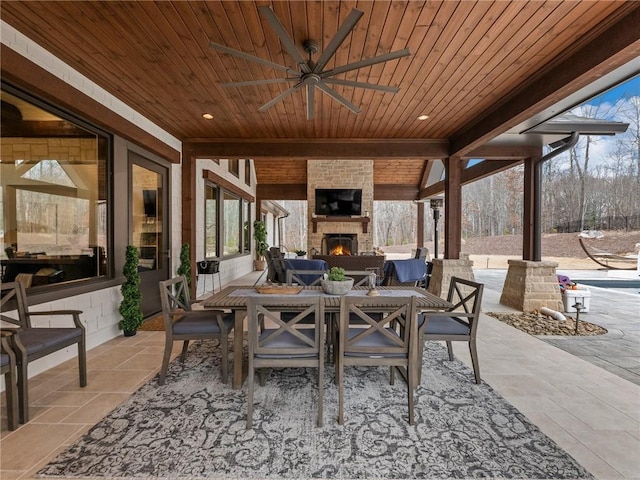 view of patio featuring a fireplace and a ceiling fan