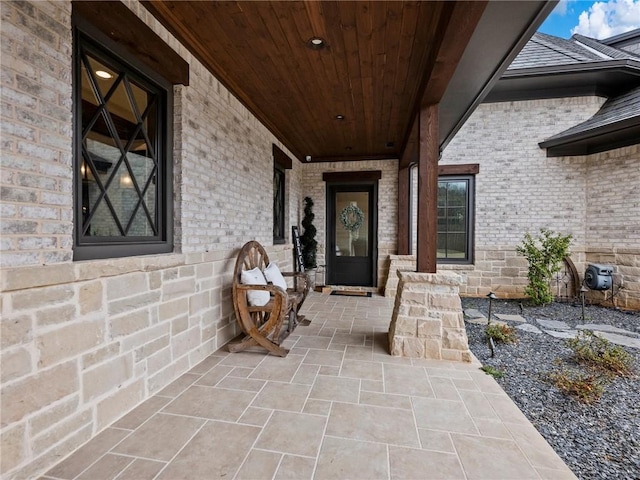 view of exterior entry featuring brick siding