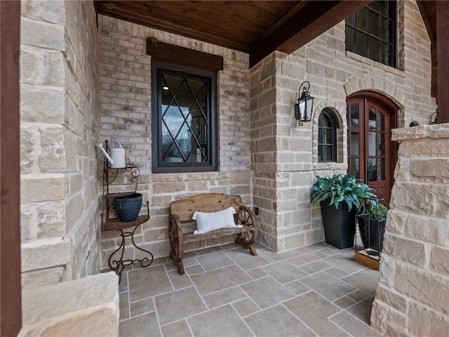 doorway to property with stone siding