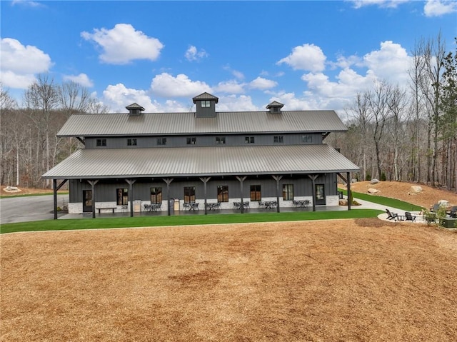 exterior space with a yard and metal roof