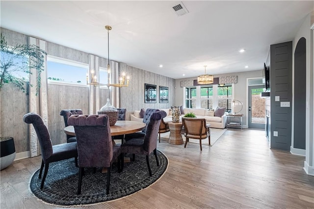 dining area featuring an inviting chandelier and hardwood / wood-style floors