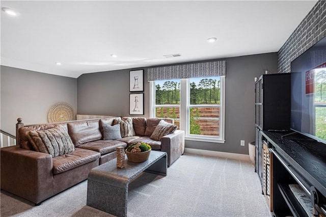 carpeted living room with vaulted ceiling