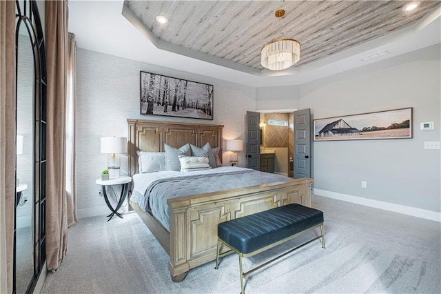 bedroom with carpet flooring, wood ceiling, and a tray ceiling