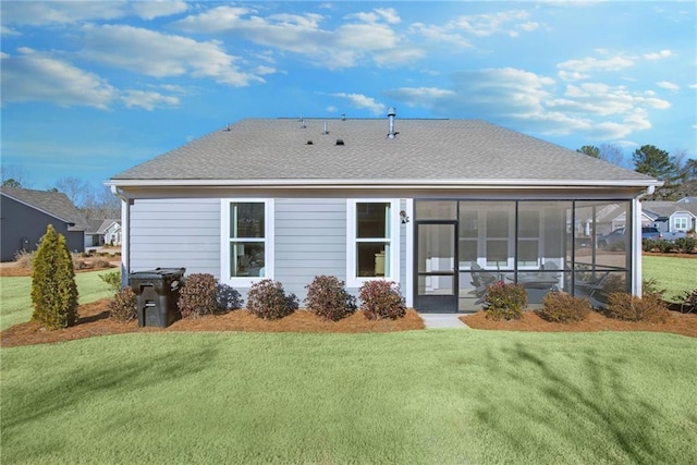 back of house featuring a lawn and a sunroom