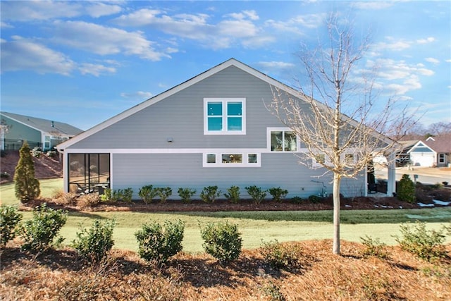 view of side of home featuring a lawn