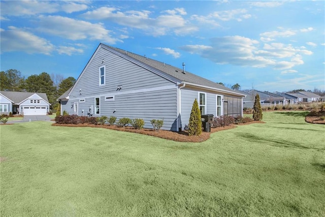 view of side of home with a garage and a yard