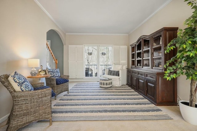 living room with arched walkways, light colored carpet, stairs, and crown molding