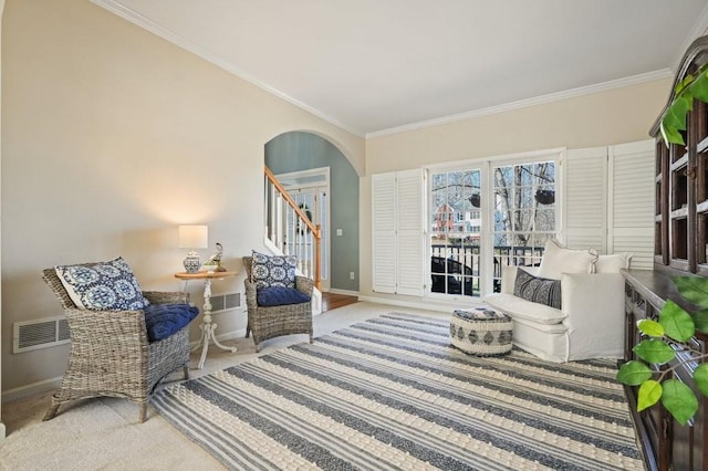 carpeted living room featuring stairway, arched walkways, visible vents, and ornamental molding