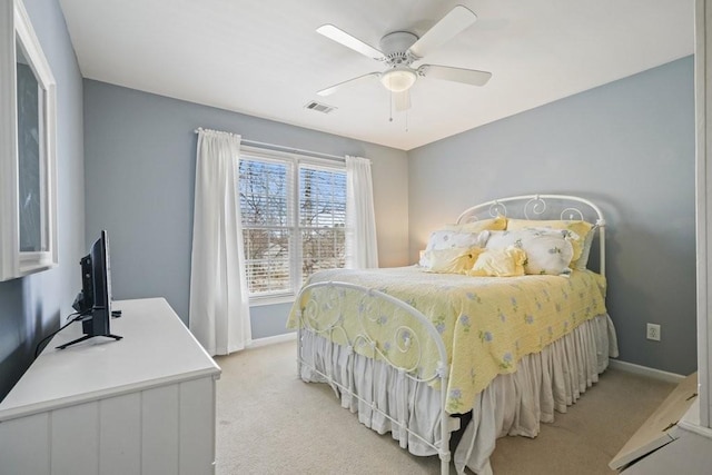 bedroom featuring ceiling fan, light colored carpet, visible vents, and baseboards