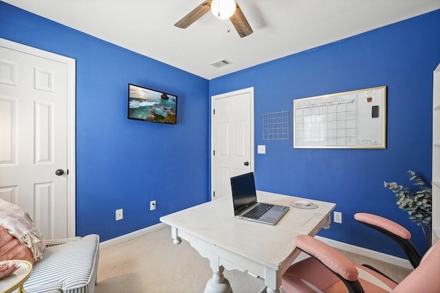 home office with visible vents, baseboards, carpet, and a ceiling fan