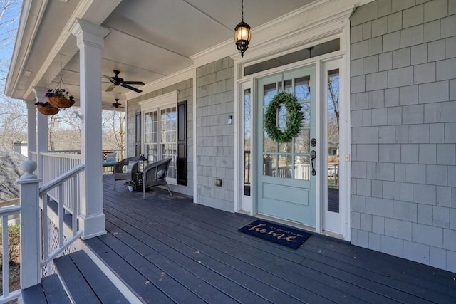 deck with covered porch and a ceiling fan