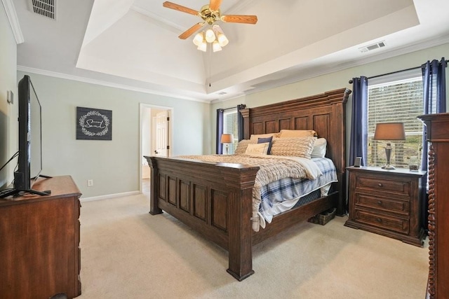 bedroom with baseboards, a tray ceiling, light carpet, and visible vents