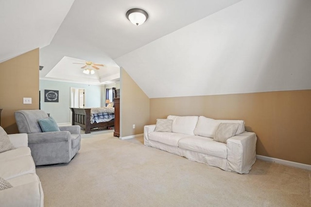 carpeted living area with lofted ceiling, a ceiling fan, and baseboards