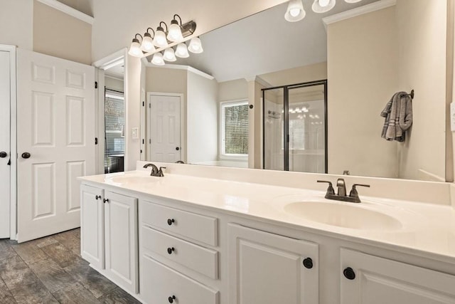 full bath with double vanity, ornamental molding, a stall shower, and a sink