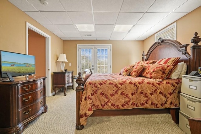 bedroom featuring visible vents, french doors, a paneled ceiling, access to outside, and light colored carpet