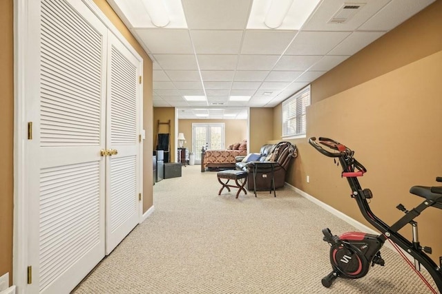 workout room with visible vents, french doors, carpet floors, baseboards, and a paneled ceiling