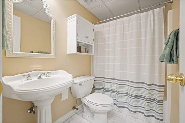 full bath featuring baseboards, toilet, shower / tub combo with curtain, and tile patterned flooring