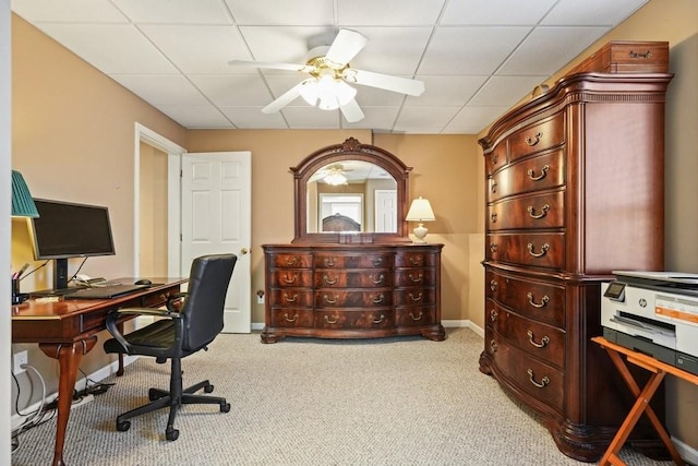 carpeted home office featuring a paneled ceiling, baseboards, and ceiling fan