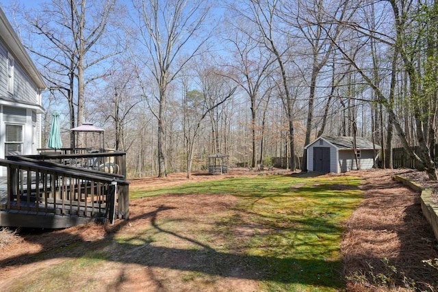 view of yard with a storage unit, a wooden deck, and an outdoor structure