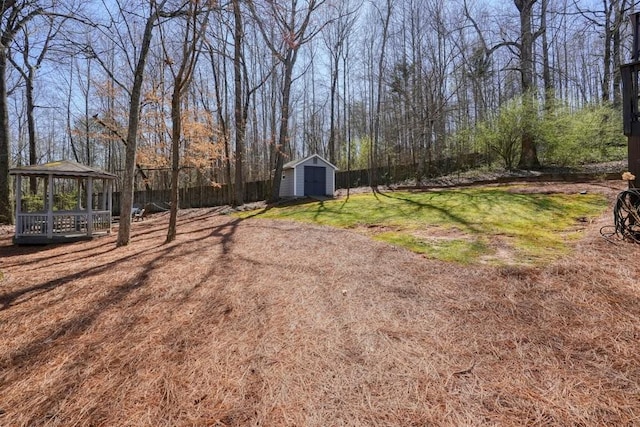 view of yard with a gazebo, an outdoor structure, and a shed