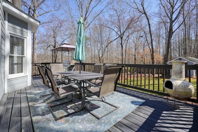 wooden deck featuring outdoor dining area