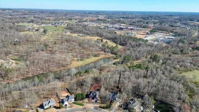 birds eye view of property with a wooded view