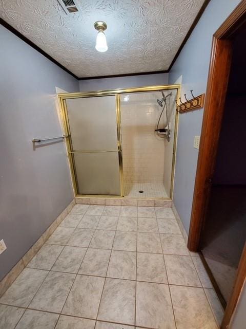 542 Banks Rd E, Fayetteville, GA 30214 - full bath with a stall shower, baseboards, tile patterned flooring, and a textured ceiling