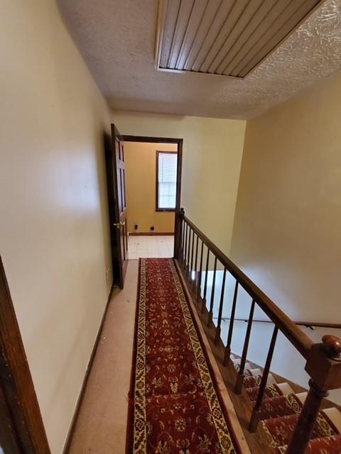542 Banks Rd E, Fayetteville, GA 30214 - hall with a textured ceiling and light carpet