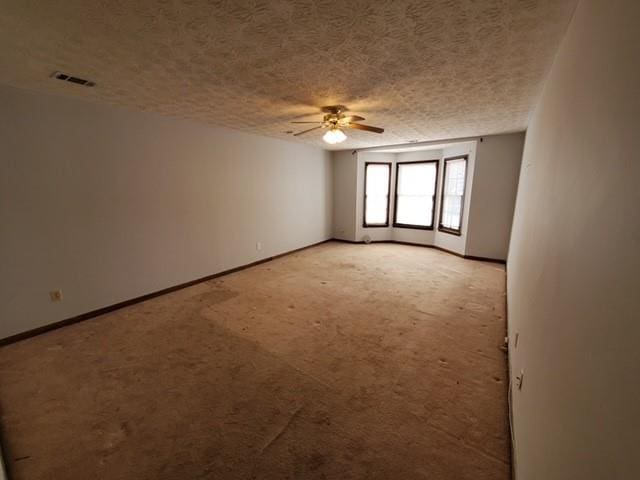542 Banks Rd E, Fayetteville, GA 30214 - spare room featuring ceiling fan, a textured ceiling, baseboards, and light carpet
