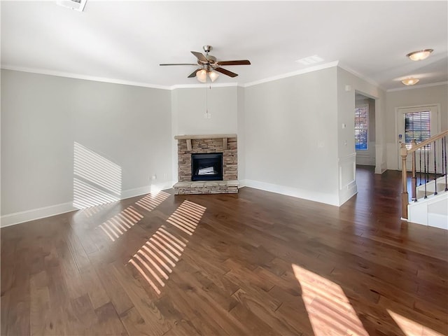 unfurnished living room featuring a stone fireplace, ceiling fan, dark hardwood / wood-style floors, and ornamental molding