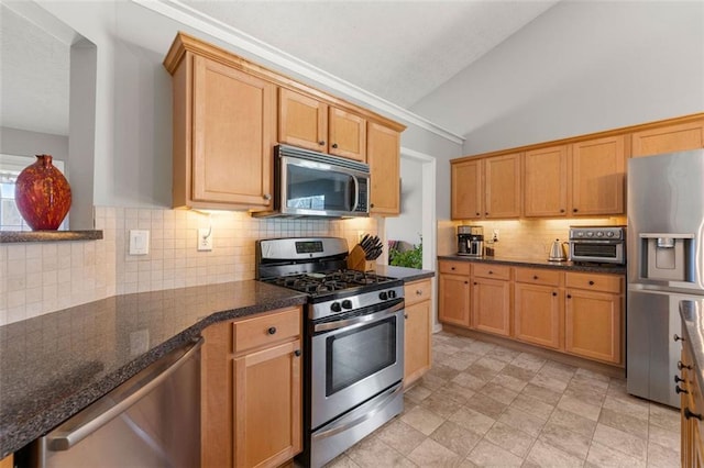 kitchen featuring a textured ceiling, dark stone counters, appliances with stainless steel finishes, decorative backsplash, and lofted ceiling