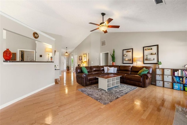 living area featuring baseboards, visible vents, high vaulted ceiling, light wood-style flooring, and ceiling fan