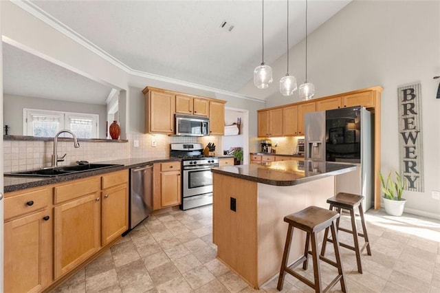 kitchen featuring visible vents, a center island, appliances with stainless steel finishes, a kitchen breakfast bar, and a sink