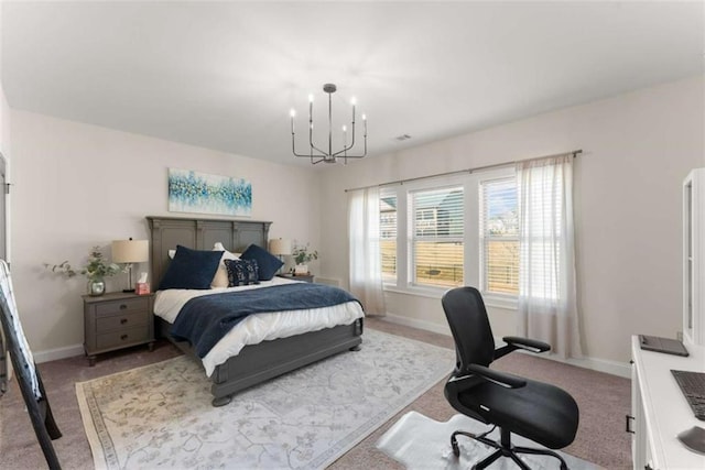 carpeted bedroom with baseboards and a notable chandelier