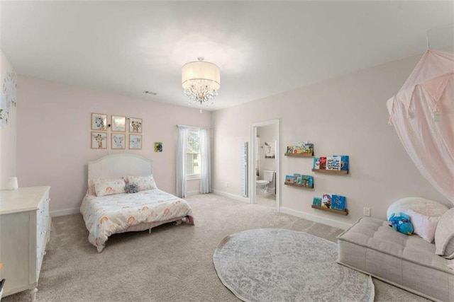bedroom with carpet floors, ensuite bath, baseboards, and a chandelier