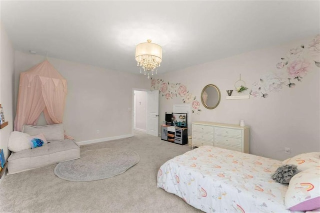 bedroom with carpet, baseboards, and a chandelier