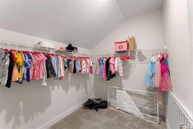 walk in closet featuring vaulted ceiling and carpet floors