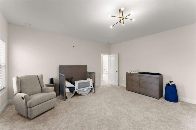 sitting room featuring baseboards, carpet floors, and an inviting chandelier
